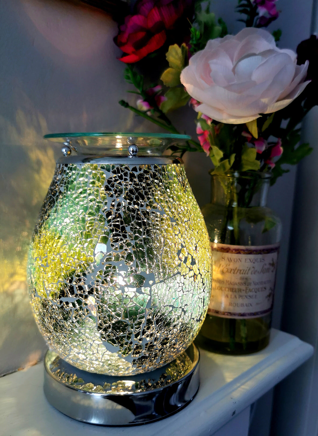 onyx green marbled crackle glass mosaic aroma lamp manufactired by desire. silver touch sensitive base. shown switched on and glowing with light  
